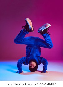 Boy child breakdancer stands on head dancing hip hop in neon light. Dance school poster. Battle competition announcement