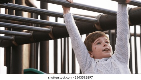 Boy, child and monkey bars at playground, outdoor and adventure with smile, learning and balance. Kid, happy and exercise with swing on jungle gym at park for challenge, climbing or sunshine in Spain - Powered by Shutterstock