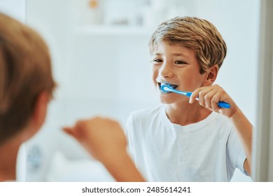 Boy child, reflection or toothbrush in bathroom for cleaning teeth, oral care or hygiene in home. Male kid, mirror or whitening with toothpaste for morning routine or wellness, dental health in house - Powered by Shutterstock