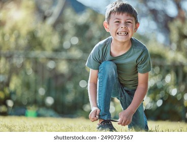 Boy, child and tie shoelace in portrait on grass, happy and backyard in summer at family house. Kid, outdoor and shoes with safety, playful and excited on lawn in sunshine with smile in Los Angeles - Powered by Shutterstock