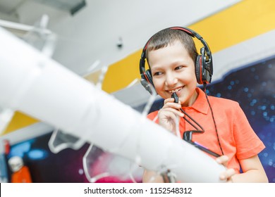 Boy Child Using Headphones And Mic At The Interactive Space Or Science Museum