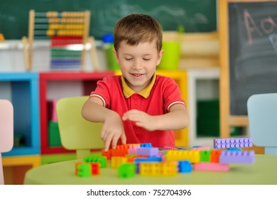 A boy in the children's room playing at the table. - Shutterstock ID 752704396