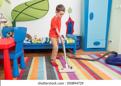 Boy Cleaning  Floor With Hoover
