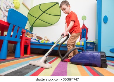 Boy Cleaning  Floor With Hoover
