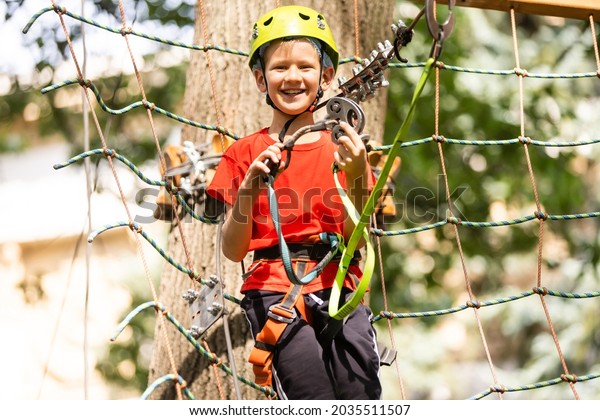 Boy climber walks on\
the rope bridge,