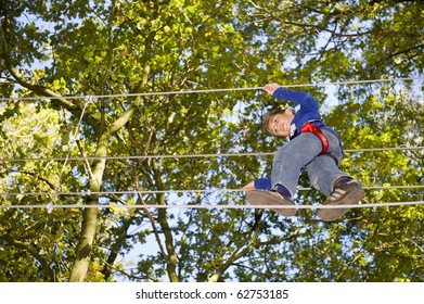 A Boy Climbing In Adventure Park