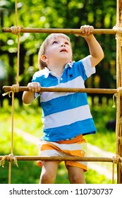 Boy Climbing A Rope Ladder