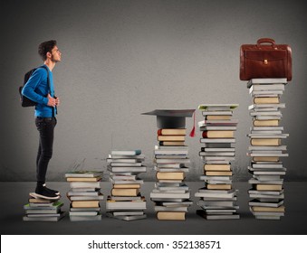 Boy climbing the stairs made of books - Shutterstock ID 352138571