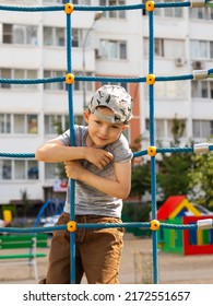 Boy Climbing Up The Stairs On The Playground