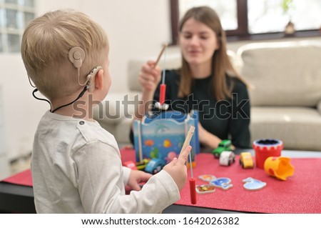 A Boy With Cochlear Implants Playing with his Mother