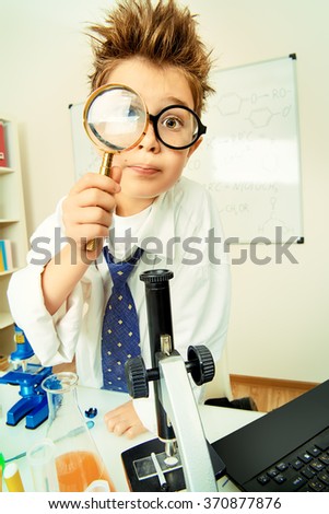 Similar – Image, Stock Photo Little boy looking at camera through magnifying glass