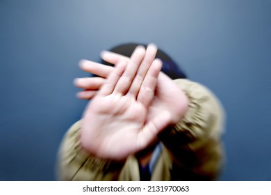 a boy covers his face - Shutterstock ID 2131970063