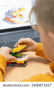 Boy creating a robot in robotics class