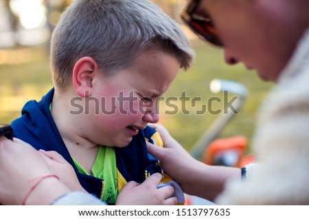 Boy crying and mom trying to calm him down. Children, parents and emotions concept