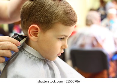 Boy cut in hairdresser's machine