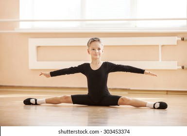 Boy Dancer Doing Splits While Warming Up At Ballet Dance Class