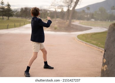 Boy Dancing In The Middle Of A Road, With Short Dress Pants And Jacket