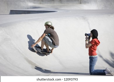 Boy dies tricks at the skateboard park as girl videotapes - Powered by Shutterstock