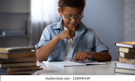 Boy with disability to learn reading and writing skills trying to concentrate