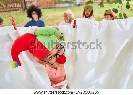 Boy disguised as a court jester at the theater play in the talent show at the summer camp