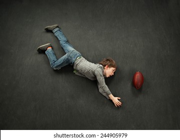 Boy Diving For The Football Catch