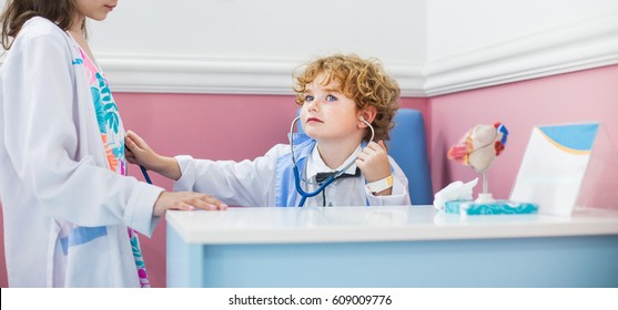 Boy Doctor, Therapist, Pediatrician, Boy In The Medical Dressing Gown Plays In The Hospital, The Day Of The Professions, Stethoscope In The Hands Of A Child, Play Choice Of Profession.