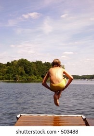 Boy Does Cannonball Off Dock - Some Movement Blur On The Boy