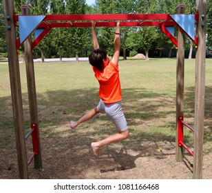 boy does gymnastics by sticking to a horizontal scale