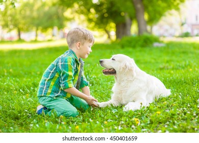 Boy with dog on green grass - Powered by Shutterstock