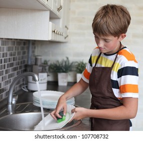 boy doing the dishes