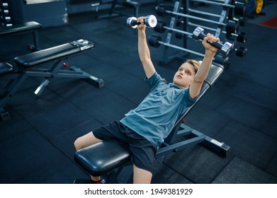 Boy Doing Exercise With Dumbbells On Bench