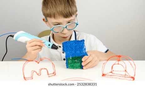 a boy is doing an extra lesson with a 3D pen - Powered by Shutterstock