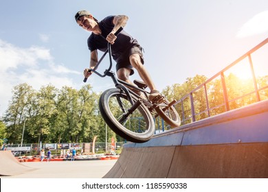 Boy Doing Jump Trick With His BMX At Skatepark