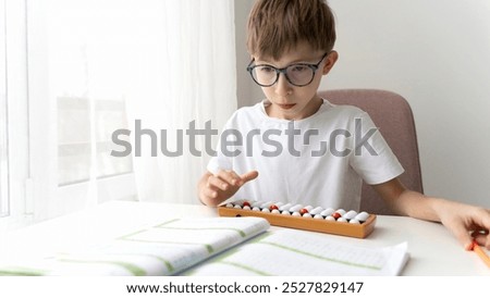 boy doing mental arithmetic on the abacus