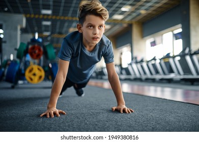 Boy Doing Push Up Exercise In Gym, Front View