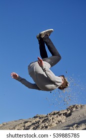 Boy Doing A Somersault In The Dunes