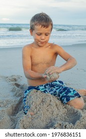 Boy doing a somersault on the sand on the beach. child having fun on the beach. Vacations by the sea. Outdoor activities with children. Summer swimming.