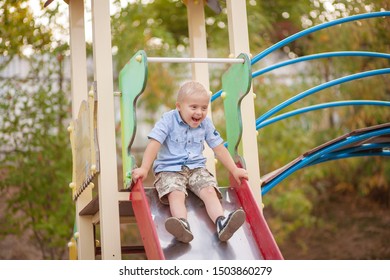 A boy with Down syndrome plays in the playground. Genetic disease in a child. - Shutterstock ID 1503860279