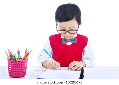 Boy is drawing with his pencil color isolated on white