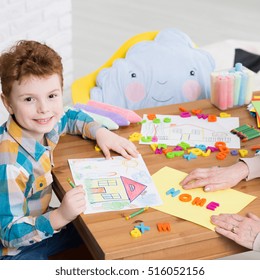 Boy Drawing A Home During Occupational Therapy