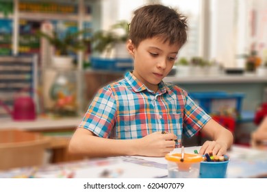 Boy Drawing In The Kinder Garden