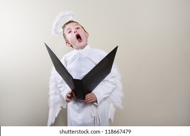 Boy dressed as an angel singing
