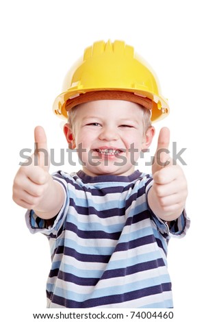 Boy dressed up as a constructuon worker with helmet holds his thumbs up
