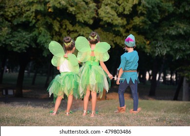 Boy dressed as Peter Pan and two girls in fairy costume