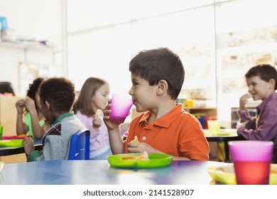 Boy drinking water during snack time in elementary school - Powered by Shutterstock