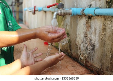 The boy is drinking water from the tap - Powered by Shutterstock