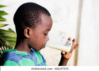 boy drinks milk in a glass.