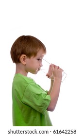 boy drinks water from a glass on a white background