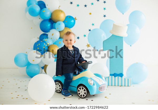 Boy drive toy car at\
first birthday
