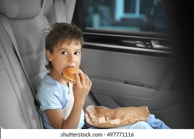 Boy Eating In Car